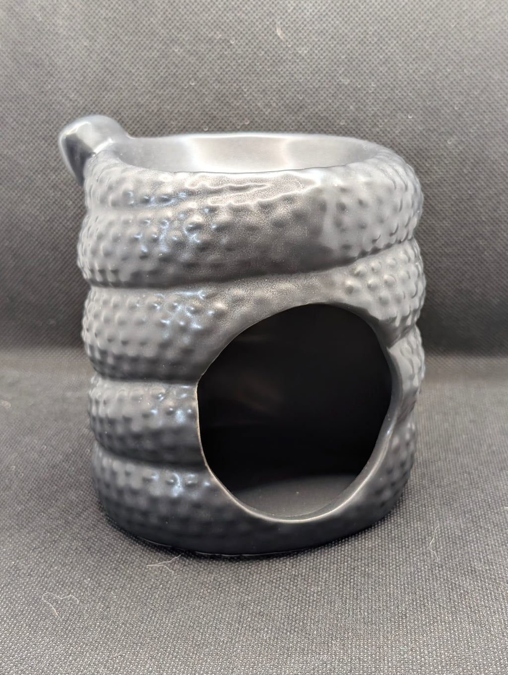 Serpentine wax/oil burner