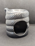 Serpentine wax/oil burner