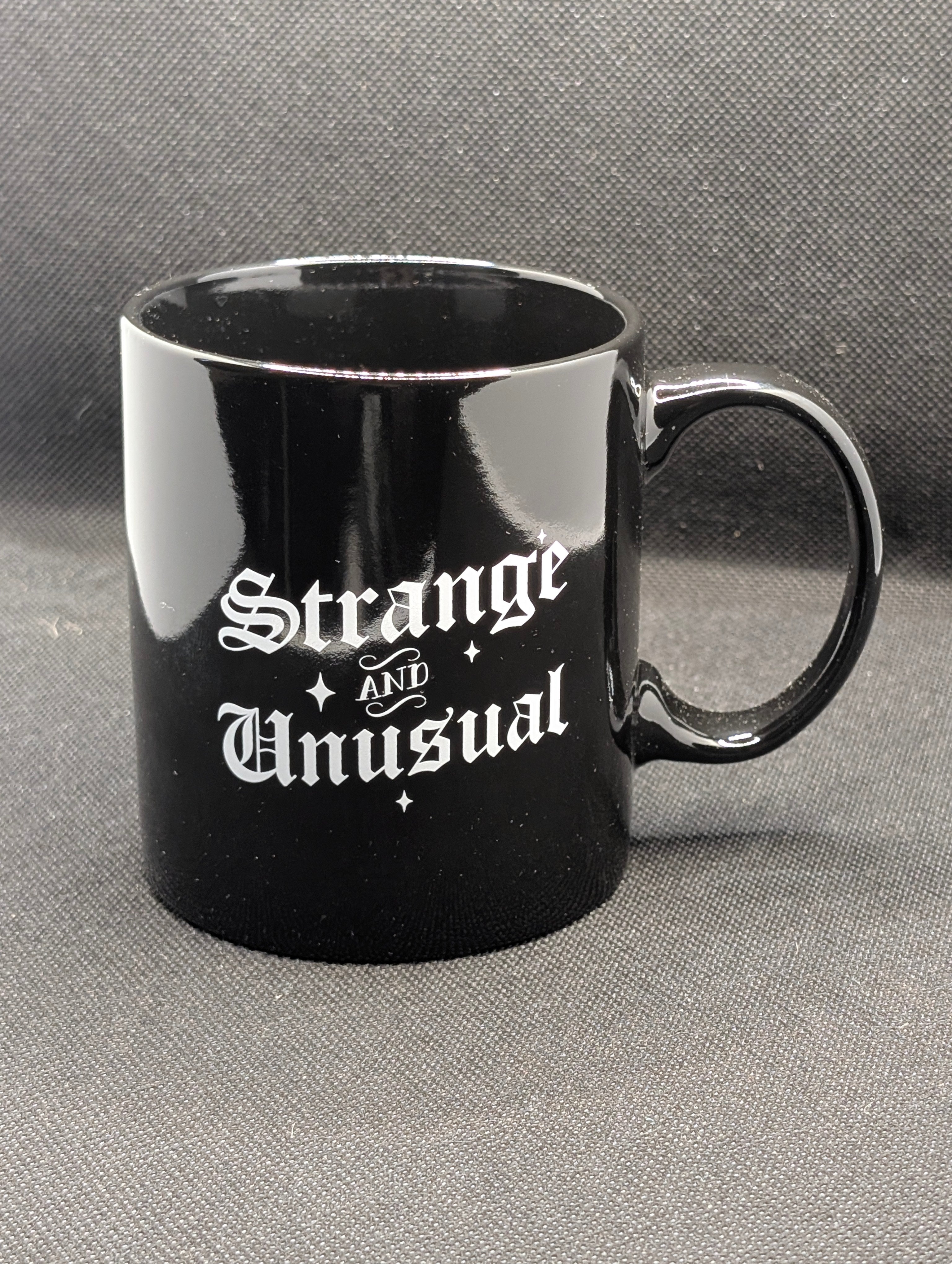 Strange and Unusual mug